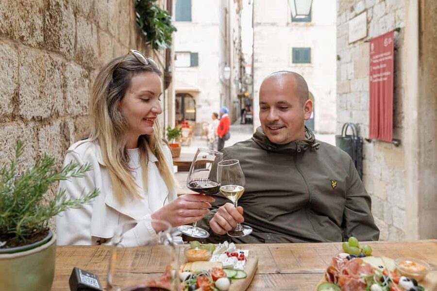 Dubrovnik Old Town: Night tour with History, Wine & Bites - The wine bar finish: 2 glasses, white and red, plus prosciutto and cheese