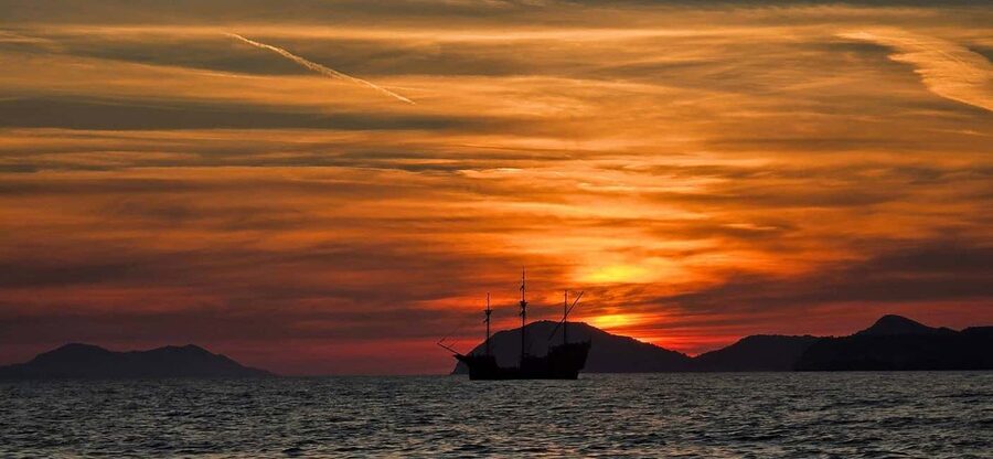 Glassboat sunset tour around Old Town & Caves in Dubrovnik - The cave highlight: entering Pigeon Cave plus a second sea cave stop